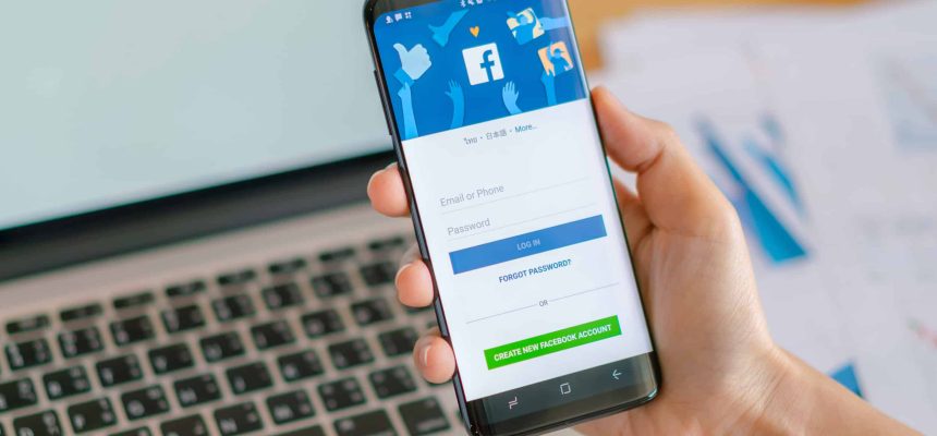 Loei, Thailand - May 10, 2017: Hand holding samsung s8 with mobile application for Facebook on the screen